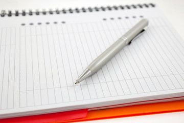pen and paper orange notebook