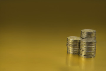 British One Pound Coins on a Gold background