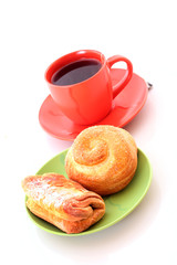 Buns and cup of tea on white