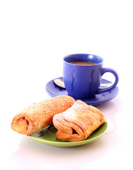Buns and cup of coffee on white