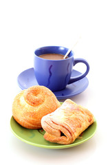 Buns and cup of coffee on white