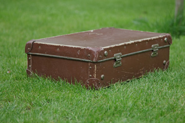 old suitcase on green grass