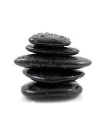 Stacked black spa stones over white background