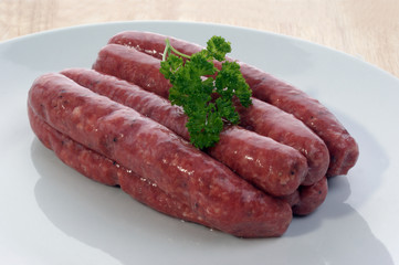 beef black pepper sausages on a white plate