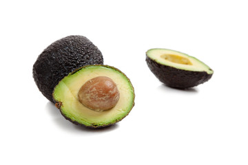 Two avocados on white