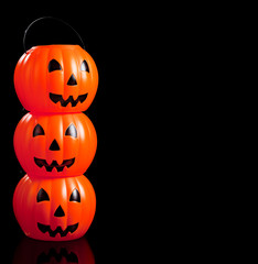 Stacked jack-o-lanterns on black