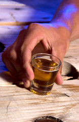 Person holding shot glass