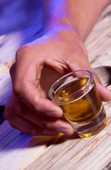 Person holding shot glass