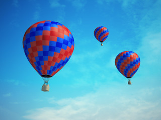 Three colorful hot-air balloons on a blue sky background