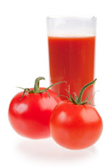 Ripe red tomatoes and glass of tomato juice.