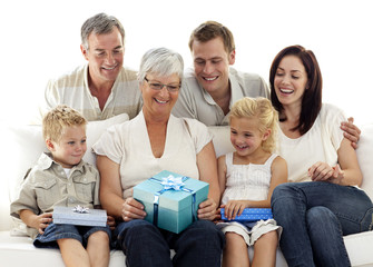 Family giving a gift to grandmother