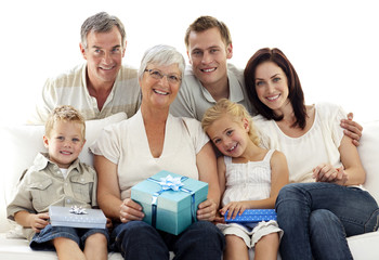 Family giving a present to grandmother