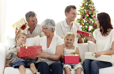 Obraz na płótnie Canvas Family opening Christmas gifts at home