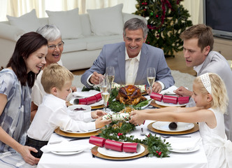 Children pulling a Christmas cracker at home