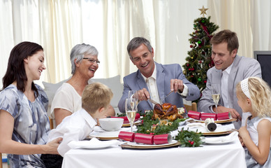 Family eating turkey in Christmas Eve