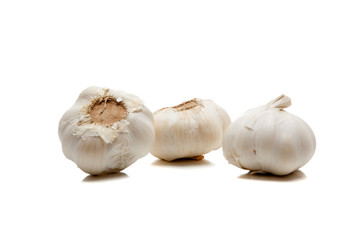 Three cloves of garlic on white