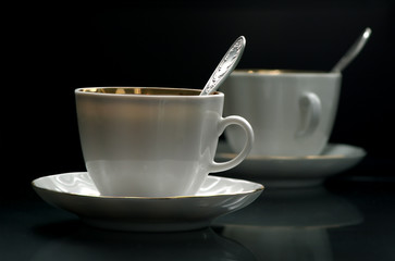 White cup of coffee about the ferry on a black background