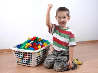 boy playing with plastic blocks