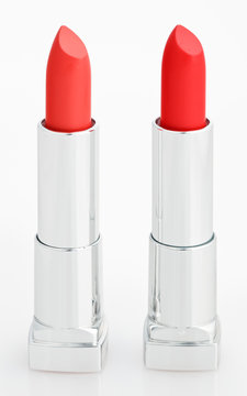 Two red lipsticks isolated on white