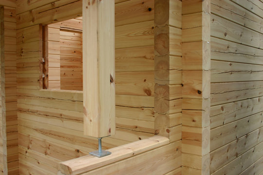 Construction of planed pine log cabin