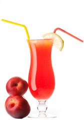 Organic juice made from peaches surrounded by fresh fruits.