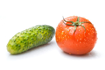 red tomato and green cucumber with water drops isolated on white