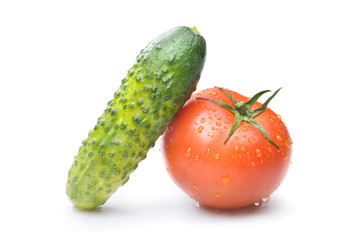 red tomato and green cucumber with water drops isolated on white