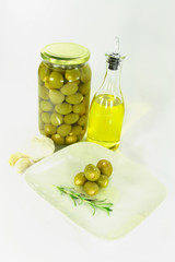 Stuffed pickled Olives in dish with olive oil.