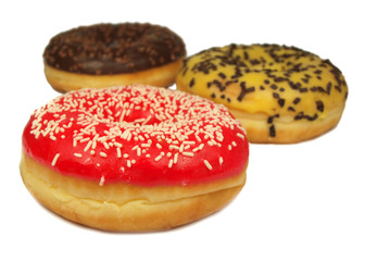 Three colored donuts isolated on white
