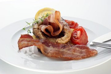 carp fillet with bacon and organic tomato