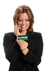 Fototapeta premium Woman Using Credit Card While on Cell Phone