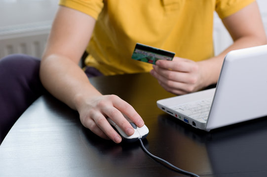 Online shopping concept, paying with a credit card at home