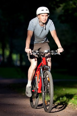 Fototapeta premium Men on mountain bike, early morning in forest.