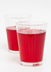 Two red cranberry fruit drinks