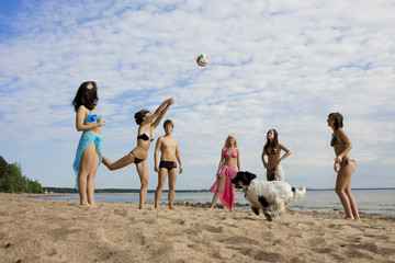 People on the beach playing volleyball