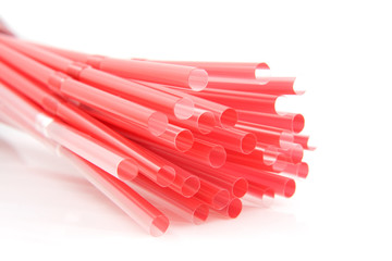 Red Colored straws in closeup over white background