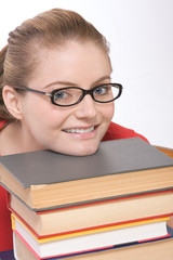 Caucasian student in eye glasses on pile of book