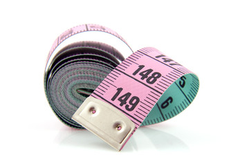 Pink measure tape over white background