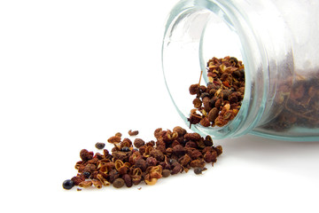fresh Szechuan pepper with glass pot over white background