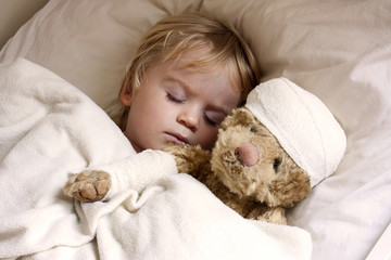 boy and teddybear in bed