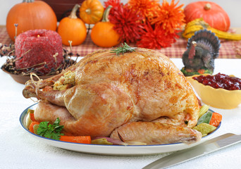 Whole roasted turkey in Thanksgiving setting.