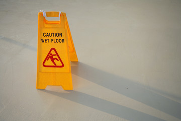 close up shot of a yellow caution on floor