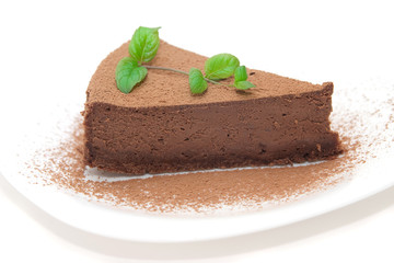 Chocolate cheesecake decorated with mint sprig