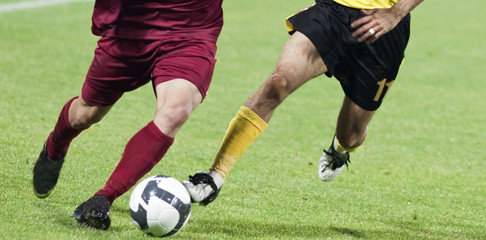 Fototapeta na wymiar Soccer players fighting for the ball