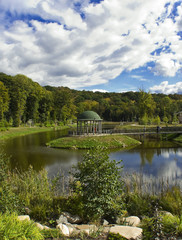 Fototapeta premium Summerhouse and wooden boardwalk in the garden