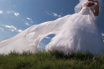 Beautiful bride on the sky background