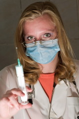 The doctor holds a syringe before vaccination