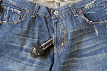 Blue-jeans with a Microphone bulging out the zipper