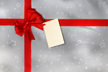 Gift with red ribbon, bow and tag
