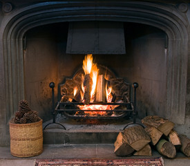Stone fireplace with a lit roaring fire - Powered by Adobe